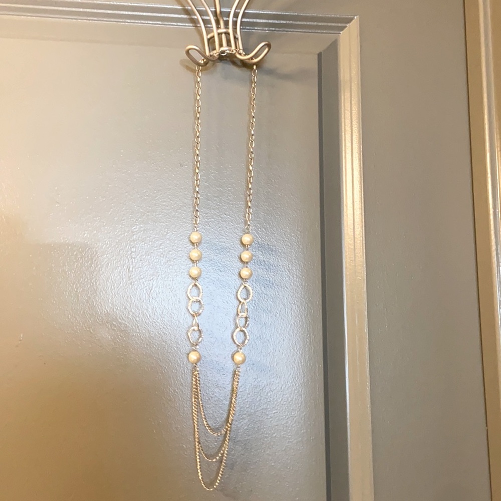 Long, layered silver and pearl necklace.